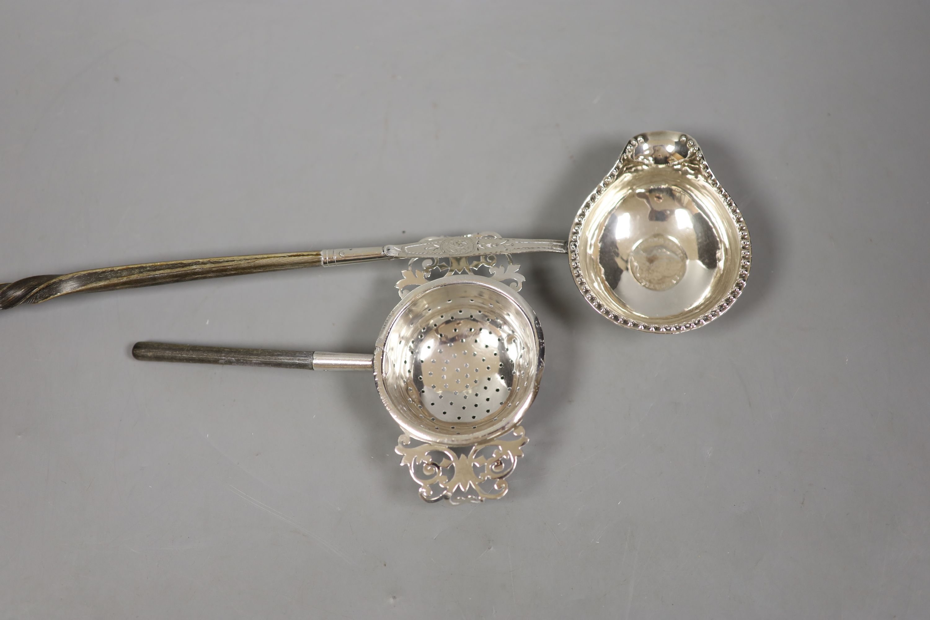 A straining ladle, Sheffield, 1909 by Harrison Brothers & George Howson, together with a coin set toddy ladle.